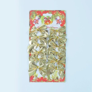 Detail of 12pcs gold metallic mini Christmas bows on a festive red hanging card