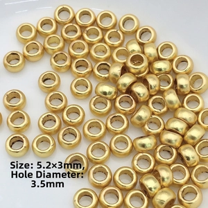 Close-up of gold spacer beads with 5.2x3mm diameter and 3.5mm hole for jewelry DIY