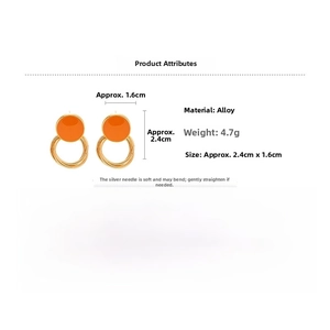Detail view of orange geometric hoop earrings with alloy gold frame and silver needle