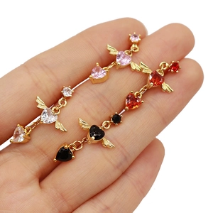 Detail showing heart shaped nose studs with angel wings in pink red white and black