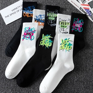 Graffiti sports socks in black and white with punk slogan on dark background
