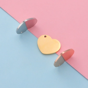 Close-up of heart-shaped pendants in gold, silver, and rose gold finishes for DIY jewelry