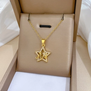 Macro shot of gold star-shaped Mama pendant with sparkling zircons in a jewelry gift box