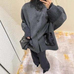 Deep grey wool coat with knit cuffs and faux fur pockets shown in a mirror selfie