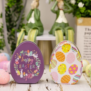 Close-up of egg-shaped Easter tin boxes with bunny and happy EASTER floral printing