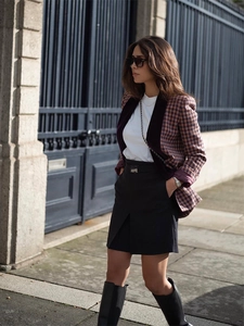 Outdoor shot of stylish brown plaid blazer jacket with velvet contrast and mini skirt
