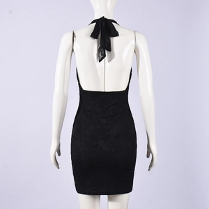 Detail of black lace dress back with halter neck bow tie and backless design on mannequin