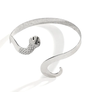 Exaggerated silver snake-shaped open arm cuff with realistic scale textures
