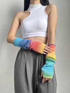 Detailed close-up showing the gradient rainbow knit texture and ribbed cuffs of the arm warmers