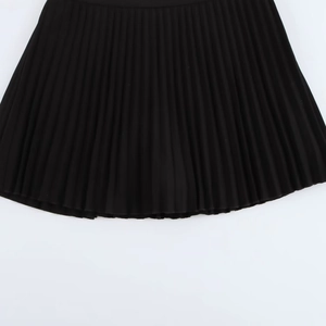Top-down view of black pleated mini skirt showing intricate texture and high-quality fabric