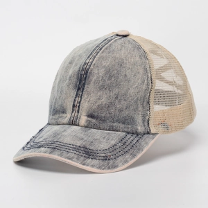 Close-up of vintage navy denim and beige mesh trucker hat with pink edge details