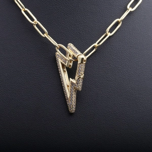 Gold lightning bolt pendant necklace with sparkling pavé stones on paperclip chain