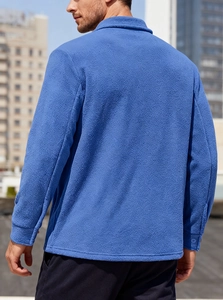 Detail of royal blue fleece texture on men's tactical outdoor jacket sleeve and cuff