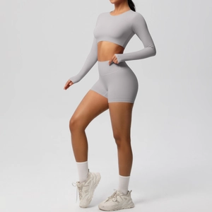 Detail of high-stretch seamless yoga set with long sleeve crop top and matching shorts