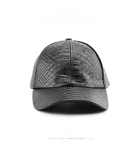 Detail of black faux crocodile leather baseball cap with glossy textured finish