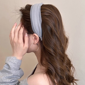 Elegant light gray pleated gauze headband for women shown on a model in side view