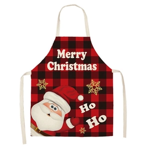 Detail of Christmas apron featuring red black plaid with Santa and snowflakes pattern