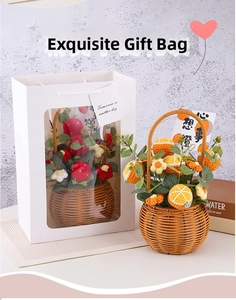 Close-up of handmade crochet flower basket with orange theme in a white gift bag