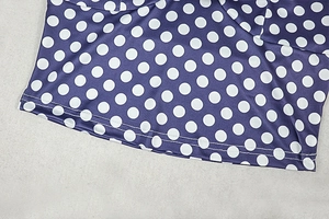 Detail of purple polka dot fabric showing professional double-needle hem stitching finish