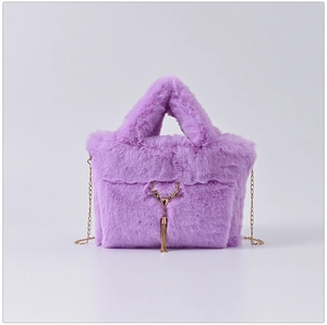 Close-up of purple faux fur handbag with golden deer head ornament and tassel detail