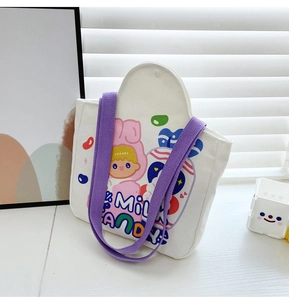 Detail of white canvas tote bag featuring purple straps and a cute cartoon rabbit print
