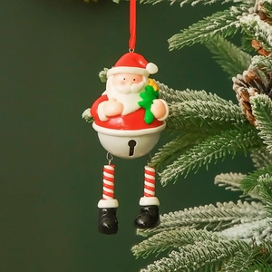 Santa Claus resin hanging ornament with metal bell and red ribbon on snowy Christmas tree
