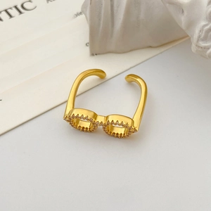 Detail of creative gold glasses ring with sparkling zircon stones and adjustable open band