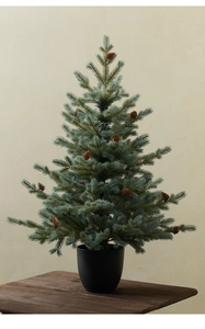 Close-up of mini PE Christmas tree with realistic pine cones in a black pot