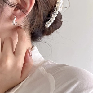 Elegant 925 sterling silver U-shaped twisted hoop earrings worn by a model on white background