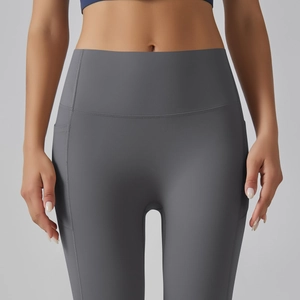 Detail view of high-waisted dark grey yoga pants featuring side pockets and fine stitching
