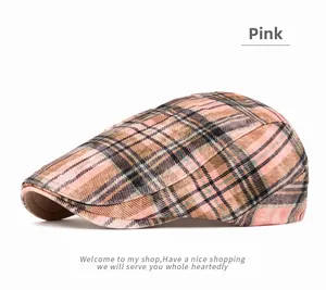 Close-up of pink plaid pattern and thick textured fabric on a retro Gatsby cap