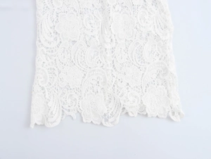Vue macro détaillée du tissu en dentelle florale blanche avec textures ajourées élégantes