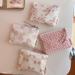 Detail of floral cotton pouches showing zippers, small patterns and side brand labels
