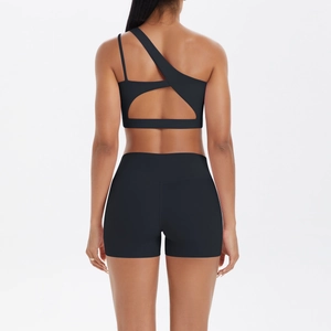 Detail of black one-shoulder sports set featuring a unique crisscross back strap design