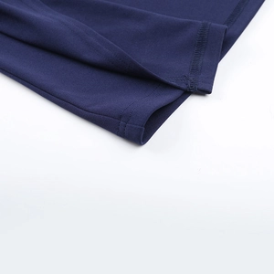 Detail of fine sewing craftsmanship and knitted texture on the navy blue dress hem