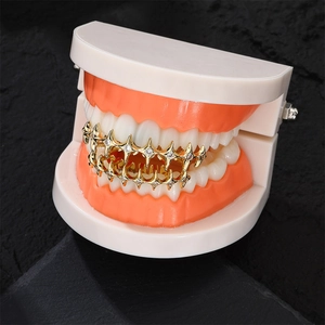 Hip hop gold grillz with iced out thorn star design on realistic dental model