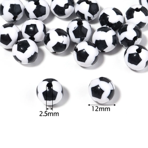 Macro detail of 12mm black and white soccer beads with 2.5mm hole for DIY crafts
