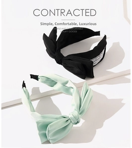 Close-up of bow headbands with pleated fabric texture and delicate lace edge detailing