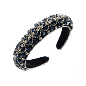 Macro view of wide velvet headband with deep blue teardrop gems and white rhinestones