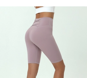 Detail view of high waist yoga shorts featuring a crisscross cutout back in taro purple