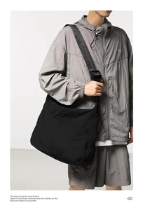 Close-up of waterproof nylon crossbody bag featuring wide adjustable strap and industrial buckle