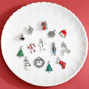 Christmas alloy charms set with tree and snowman designs on a festive red background