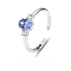 Detailed shot of an adjustable S925 silver ring featuring an oval blue gemstone and side diamonds