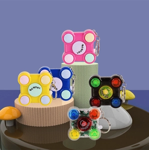 Mini memory game keychains in five colors displayed on circular stands against blue backdrop