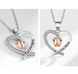 Detail view of heart necklace with baby footprints and I love you mom engraving