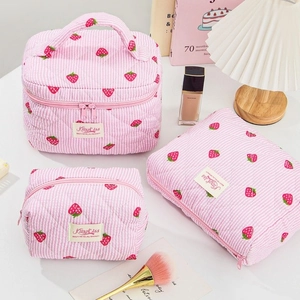 Detailed set of three pink striped quilted cotton makeup bags with red cherry pattern