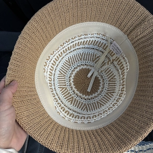 Breathable knit bucket hat with stripe pattern showing interior sweatband and care label