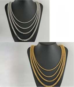 Detail of 18K gold and silver stainless steel spiga wheat chains for men