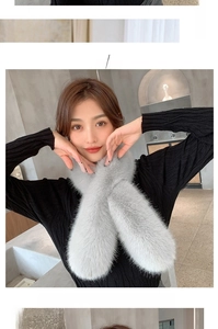 Close-up of light gray faux fox fur scarf with a soft plush texture and cross-over design