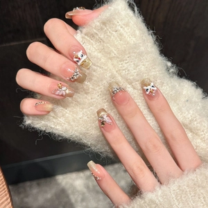Handmade press-on nails with golden glitter, 3D lion dance charm and pearl accents